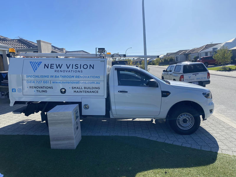 White ute signwritten for New Vision Renovations: bathroom renovations, tiling and small building maintenance